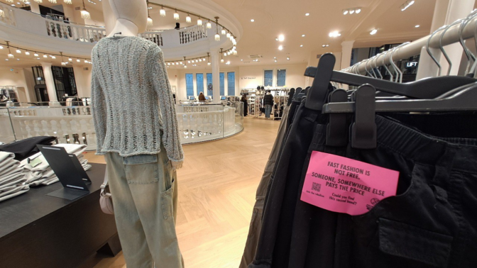 picture from a fashion store with one of our labels attatched to pants that reads: fast fashion is not cheap - someone somewhere pays the price
